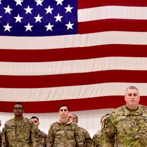 Homecoming american soldiers with flag in the background